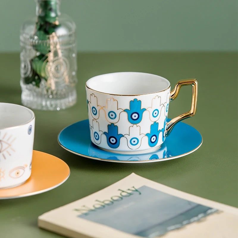 Blue Eye Ceramic Coffee Cup Sets with Gold Handles and Saucers.